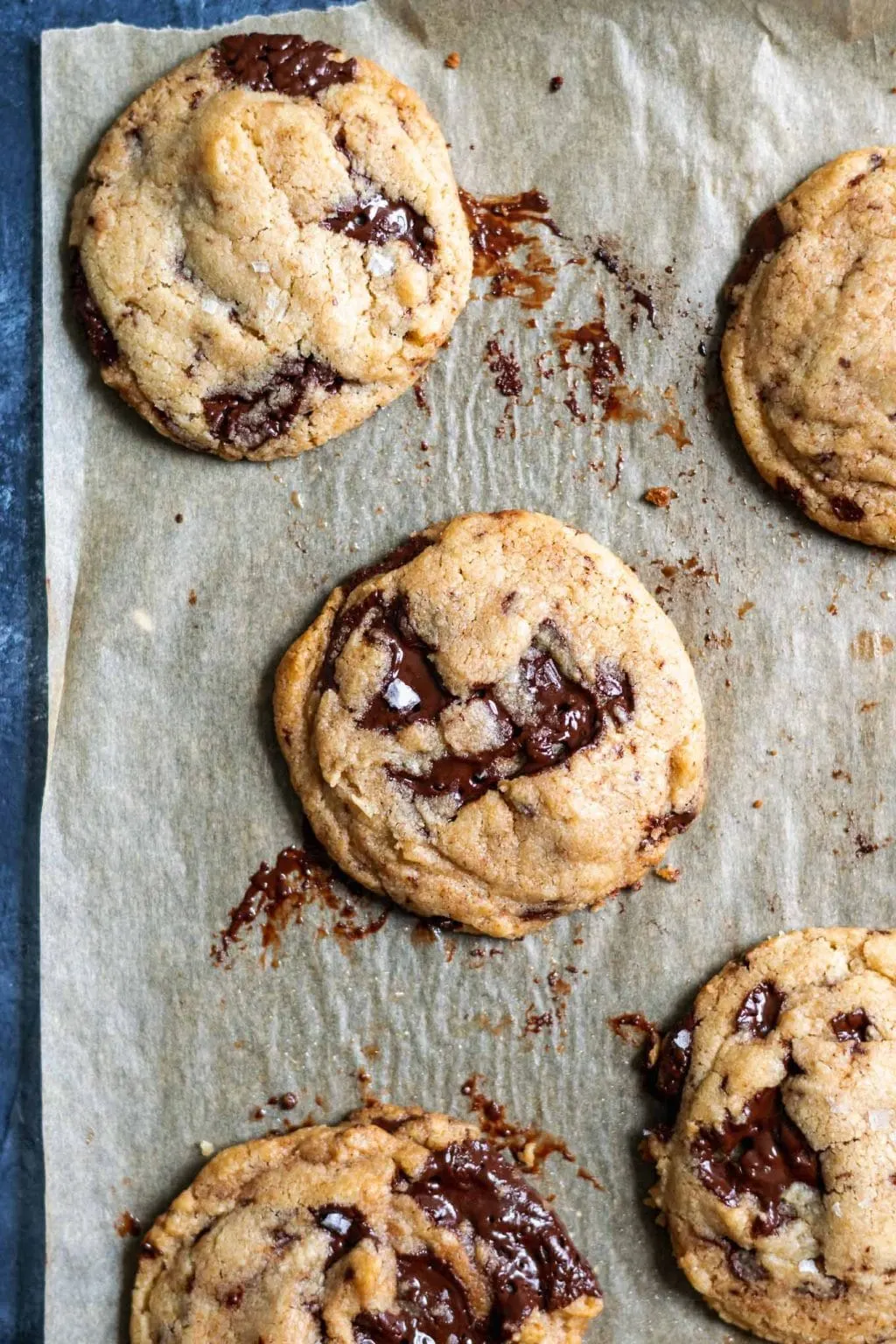 chewy vegan tahini chocolate chip cookies on a parchment paper