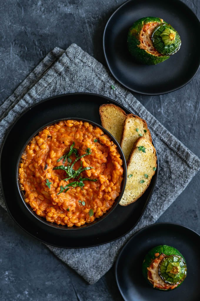 creamy vegan barley risotto stuffed zucchini served with toast