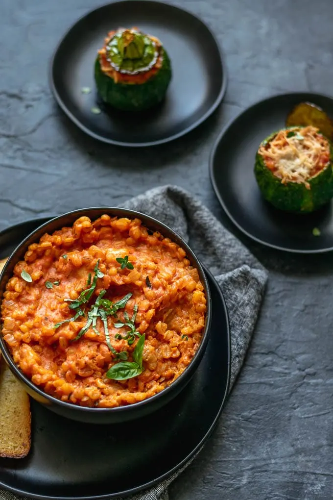 creamy vegan barley risotto stuffed zucchini