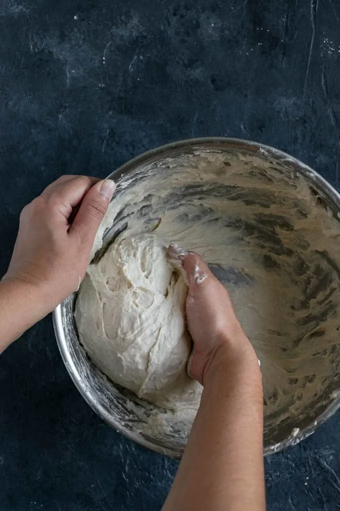kneading the wet naan dough