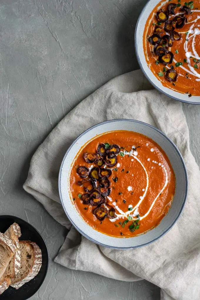easy vegan roasted carrot soup with purple carrot chips served with sourdough toast