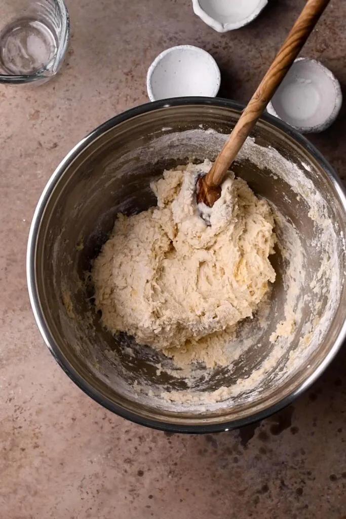 naan dough stirred together with a wooden spoon