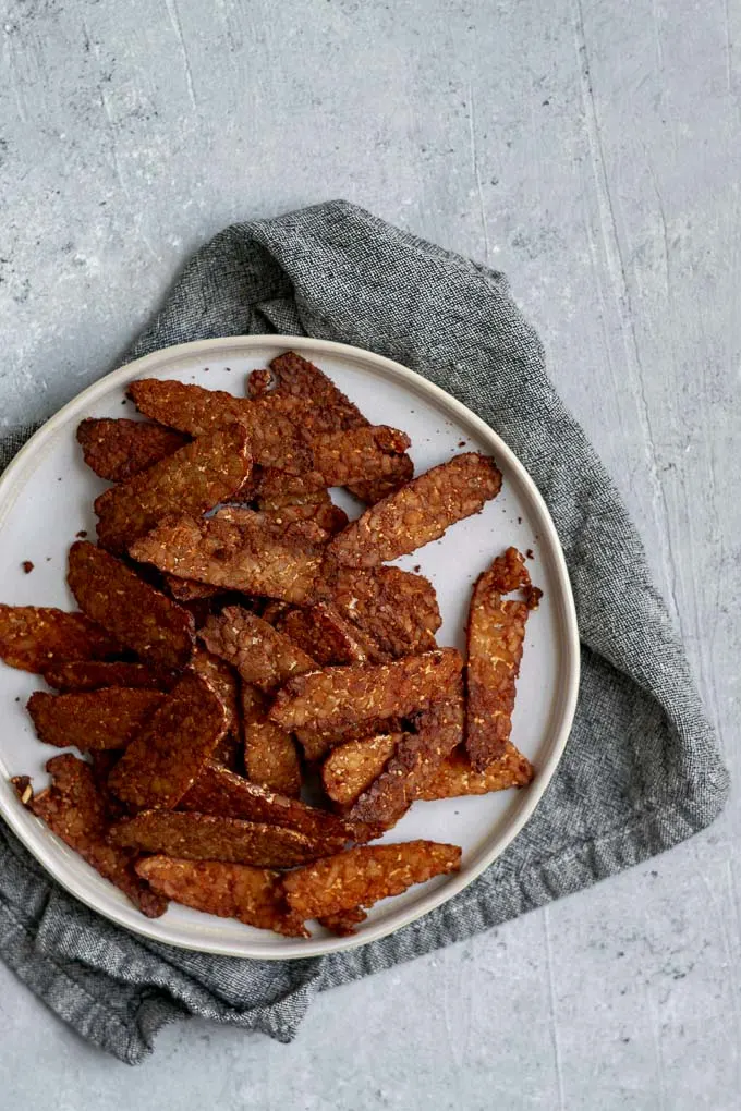 finished baked tempeh bacon on plate