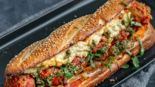Vegan chickpea meatball subs with homemade mozzarella, pesto, and caramelized onions