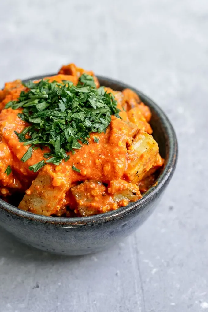 Easy romesco sauce on pan fried potatoes and garnished with parsley