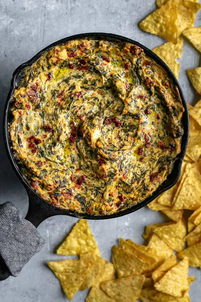 the best vegan spinach artichoke dip, baked in a small cast iron skillet