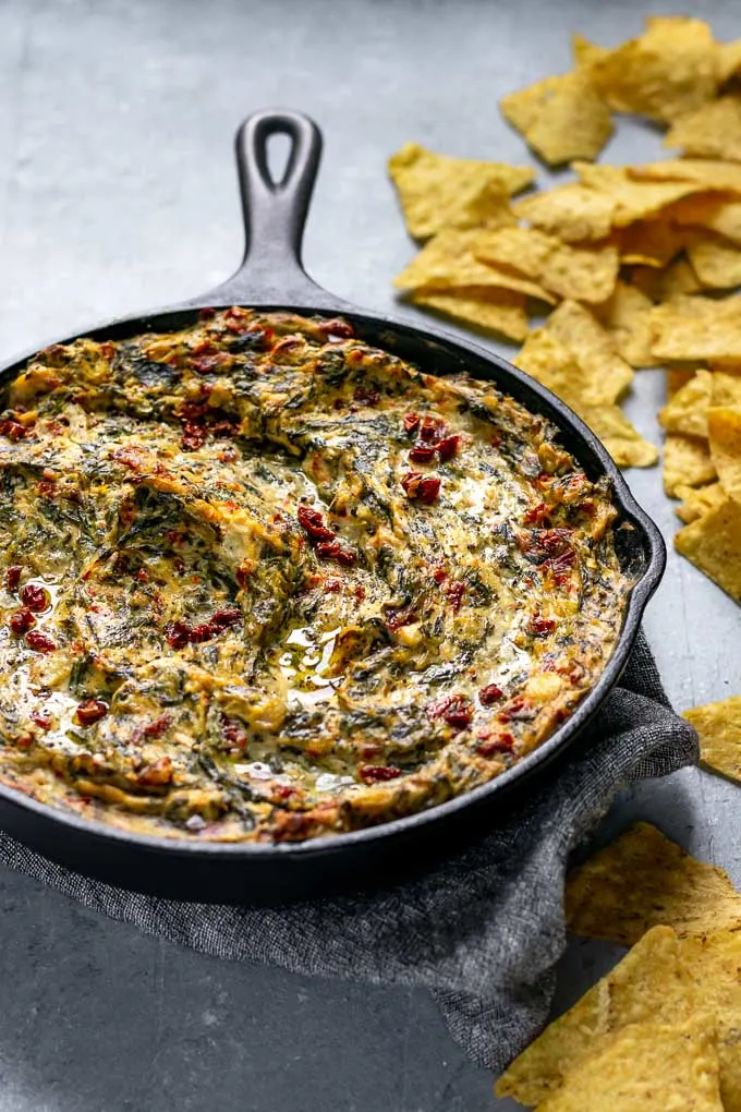 the best vegan spinach artichoke dip served with tortilla chips