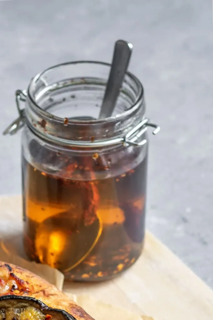 homemade chili oil in glass jar with a spoon