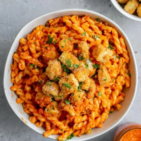 Pasta romesco topped with crispy baked tofu and seasoned toasted breadcrumbs