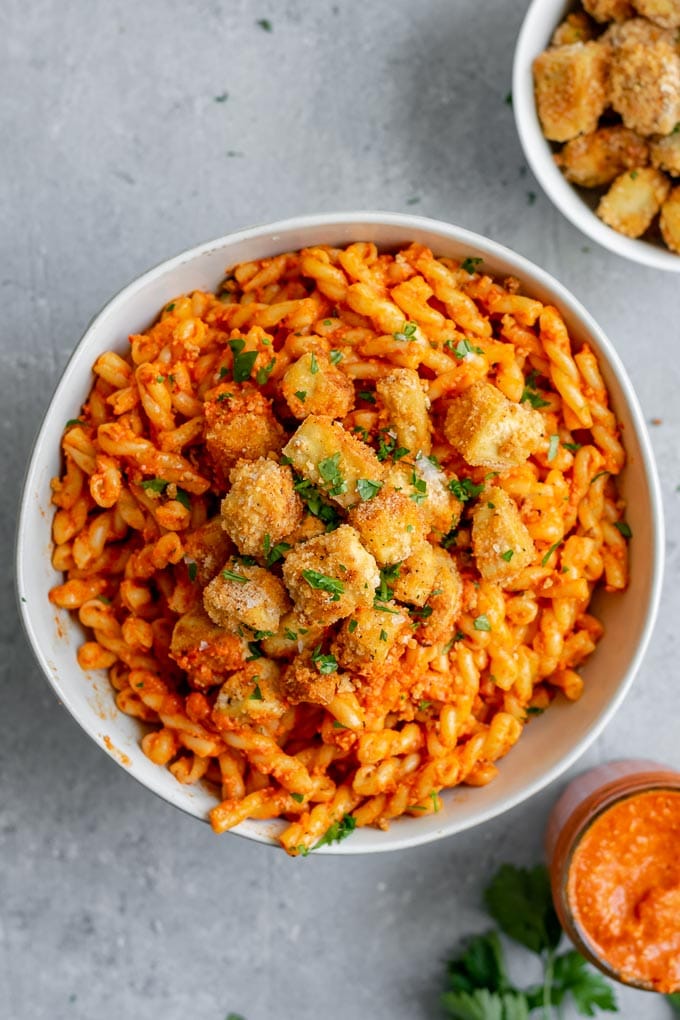 Pasta romesco topped with crispy baked tofu and seasoned toasted breadcrumbs