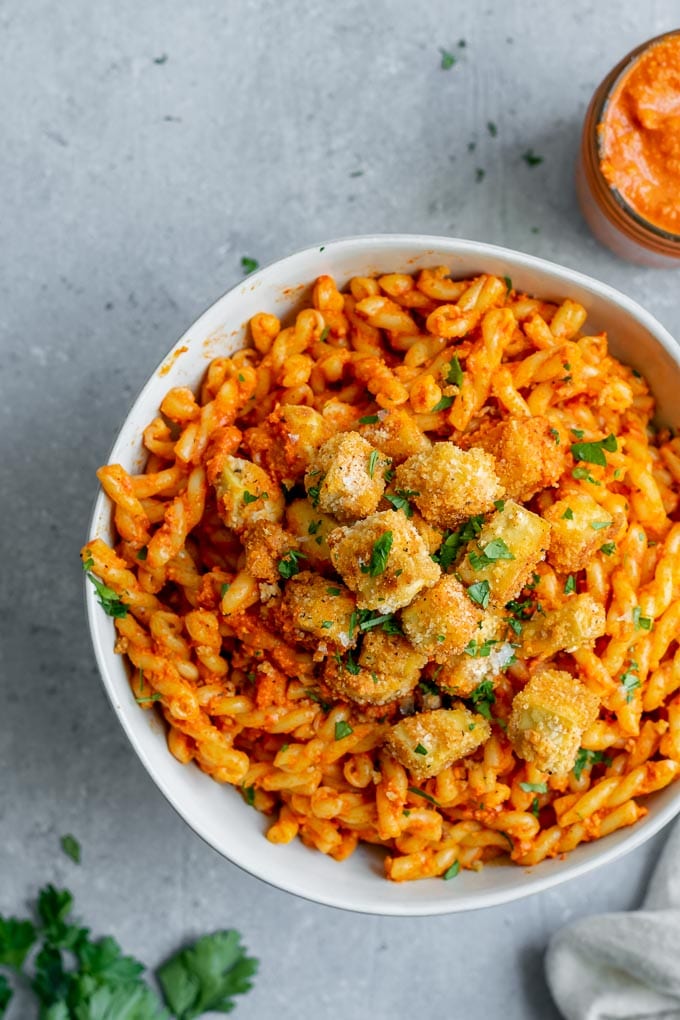 Pasta romesco topped with crispy baked tofu and seasoned toasted breadcrumbs