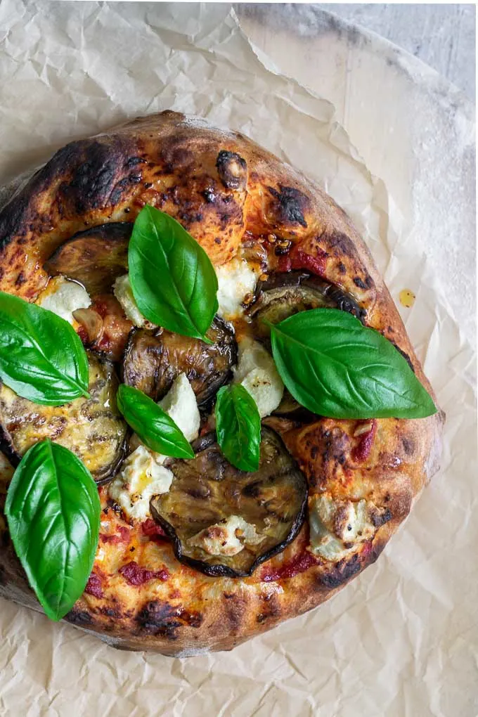 vegan roasted eggplant pizza with almond ricotta, roasted garlic, and chili oil
