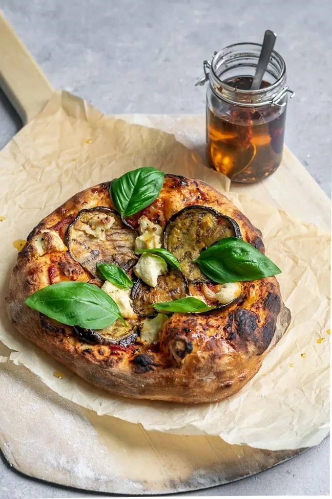 vegan roasted eggplant pizza with almond ricotta, roasted garlic, and chili oil