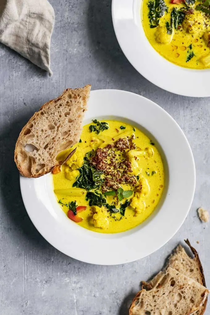Bell Pepper Coco Turmeric Stew with Quinoa and Sourdough bread from the cookbook Vegan Reset by Kim-Julie Hansen