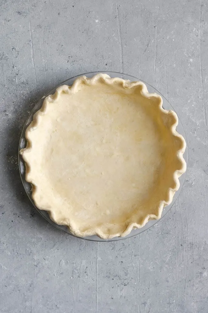 empty pie dough shell before baking