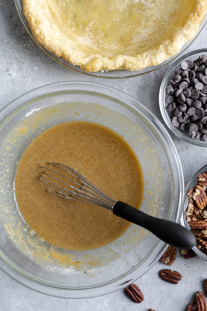 chocolate bourbon pecan pie filling mise en place and parbaked pie crust