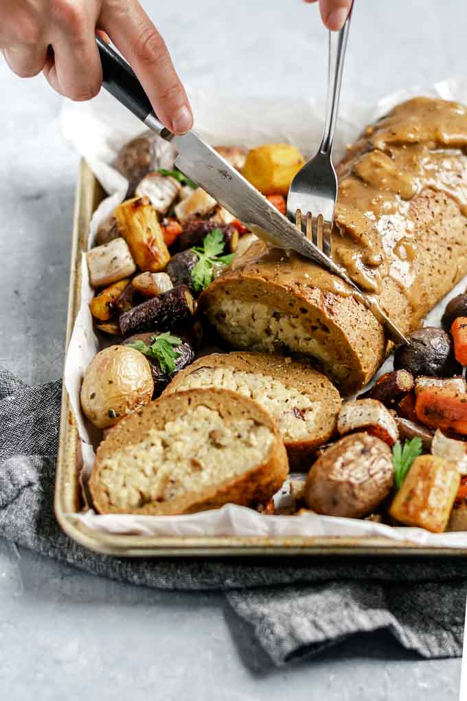 Cutting into the risotto stuffed seitan roast