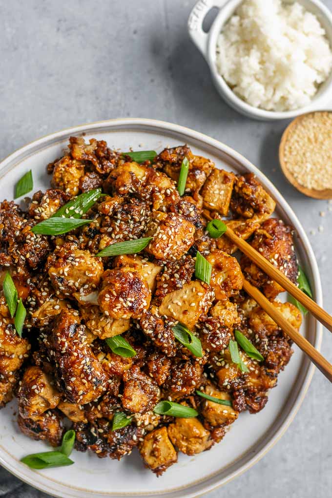 sticky teriyaki tofu and cauliflower with rice and toasted sesame seeds to serve