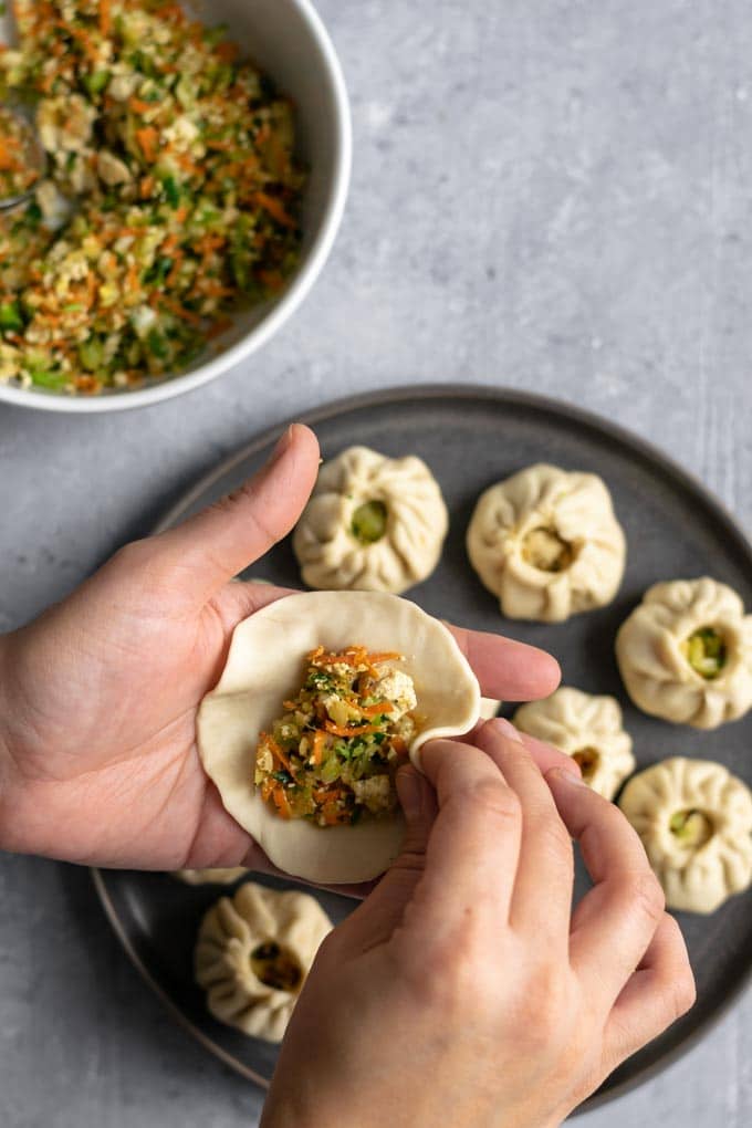 shaping Tibetan vegetable momos into a round dumpling