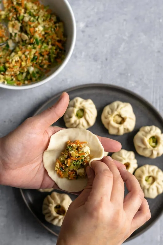 shaping Tibetan vegetable momos into a round dumpling