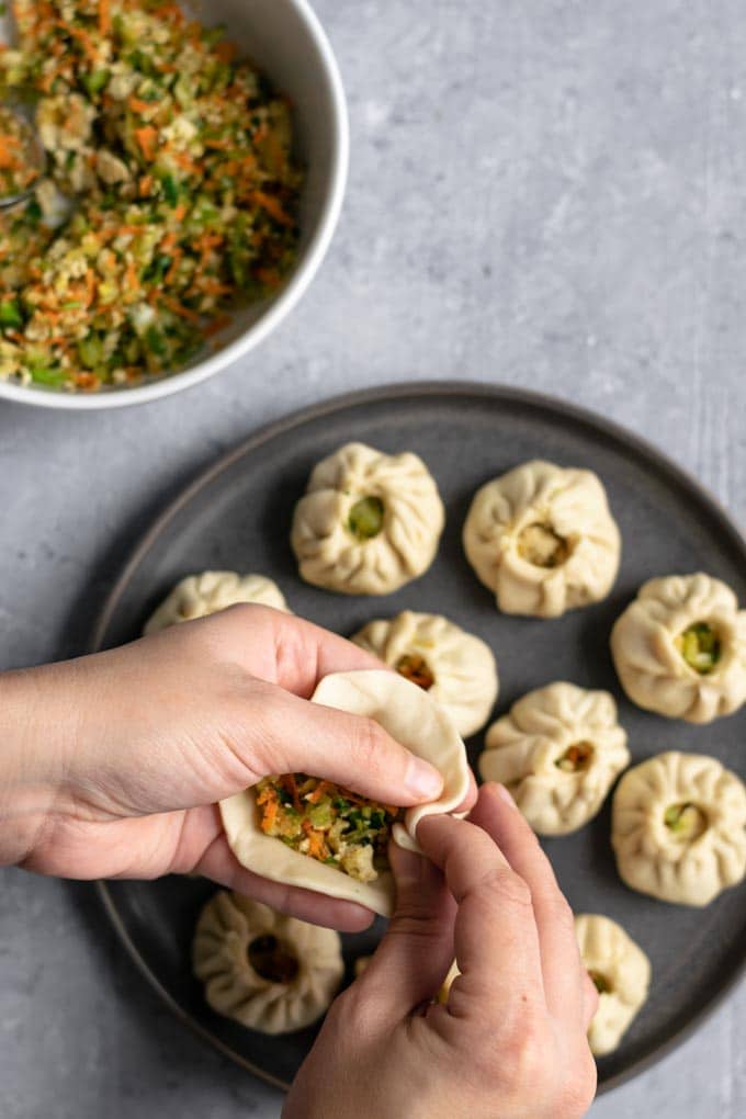 shaping Tibetan vegetable momos into a round dumpling