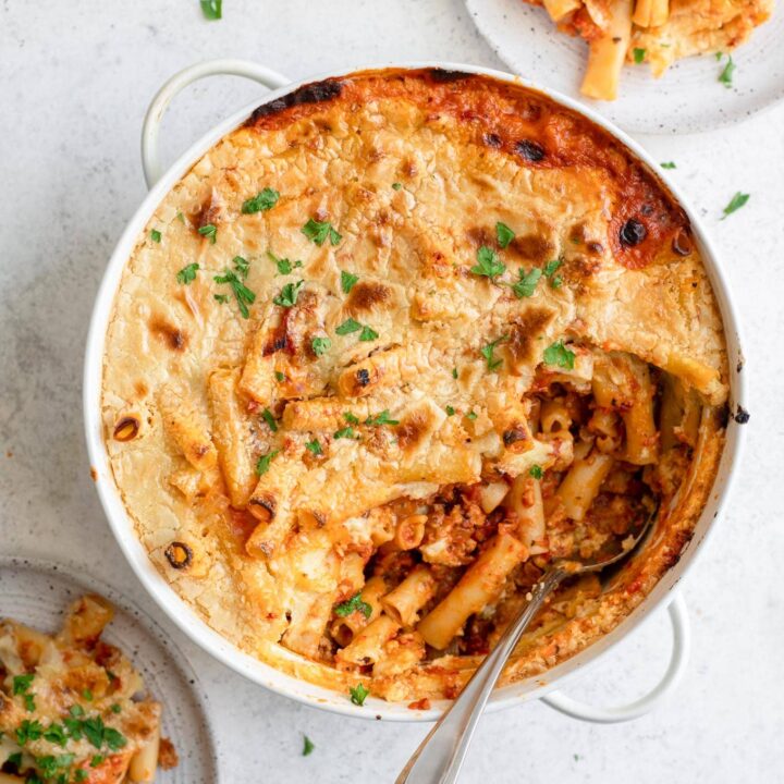 vegan baked ziti in casserole dish with two plates served