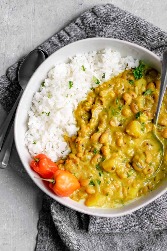 Jamaican black-eyed pea curry with rice and habanero peppers and a garnish of parsley