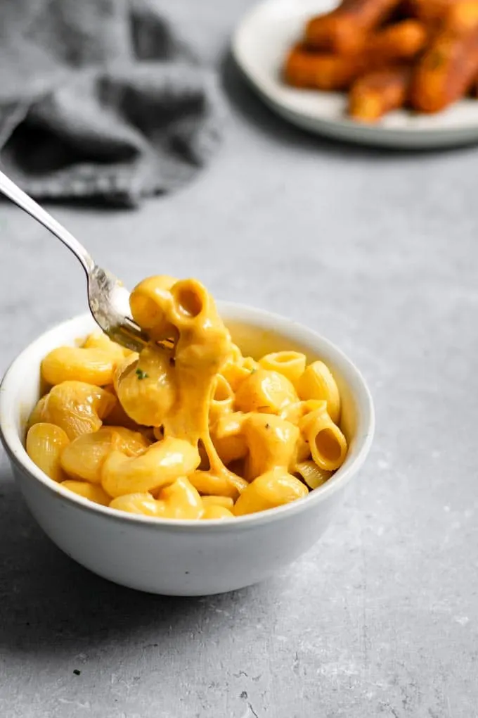 vegan coconut milk mac and cheese showing a cheese pull