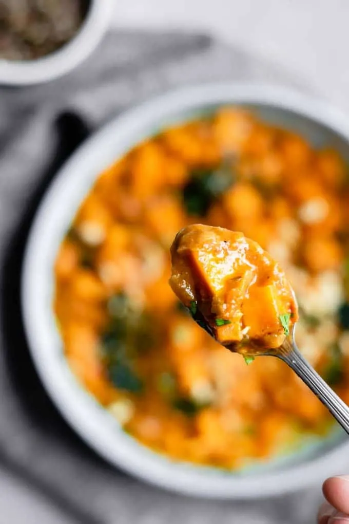 A spoonful of West African curry sweet potato, kale, and peanut stew