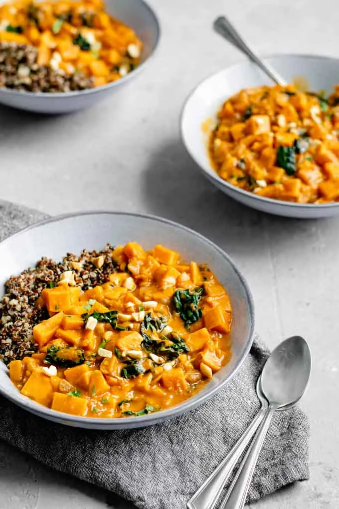 african curry sweet potato, kale, and peanut stew served with quinoa