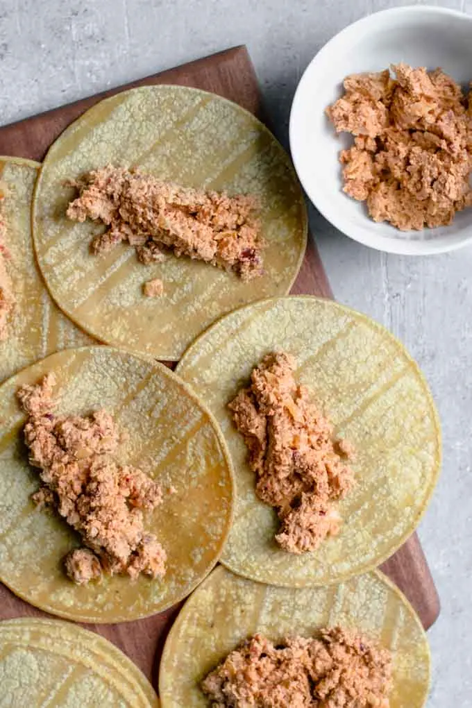 corn tortillas filled with the cheesy beefy filling before being rolled into taquitos