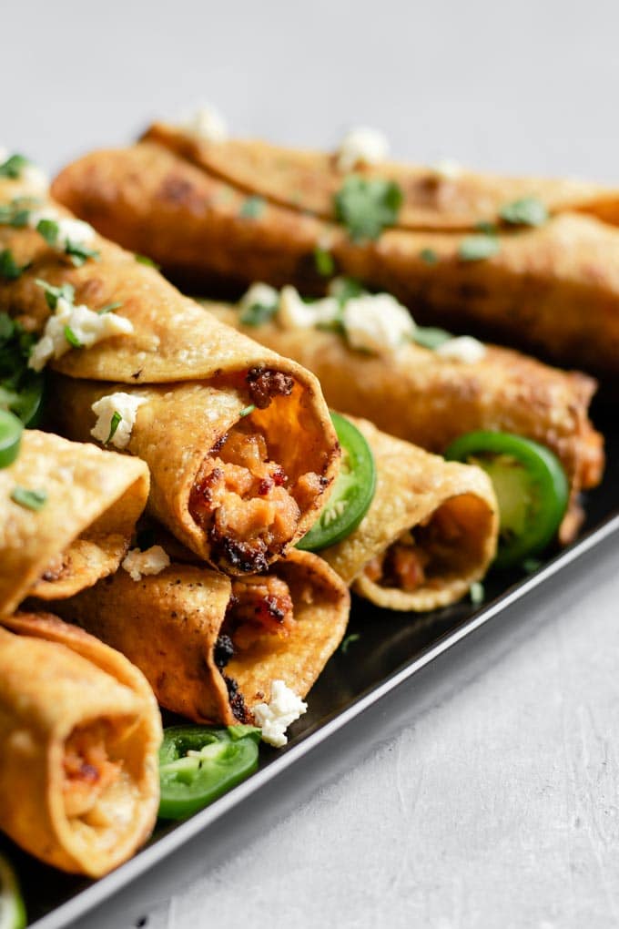 side view of the vegan cheesy beefy taquitos highlighting the filling