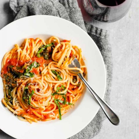 classic homemade marinara with spinach and garnished with fresh basil