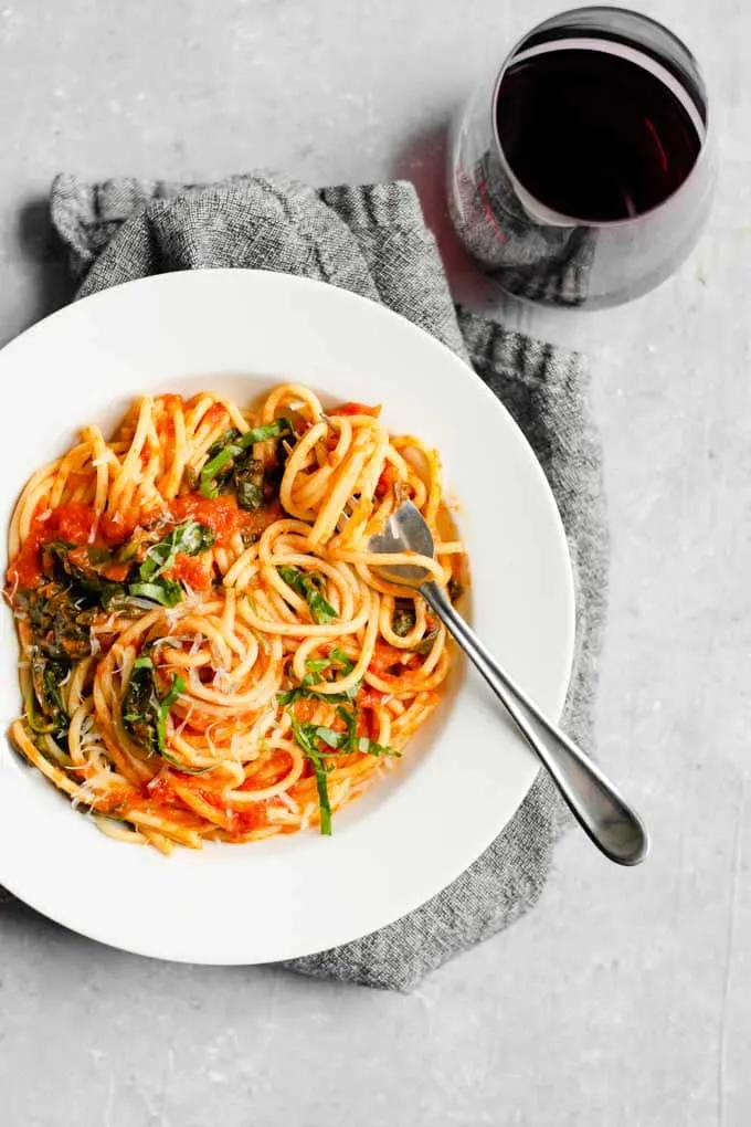 classic homemade marinara with spinach and garnished with fresh basil