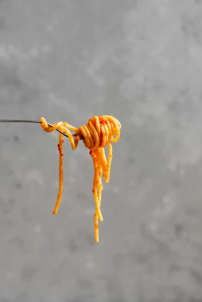 A swirl of spaghetti marinara on a fork