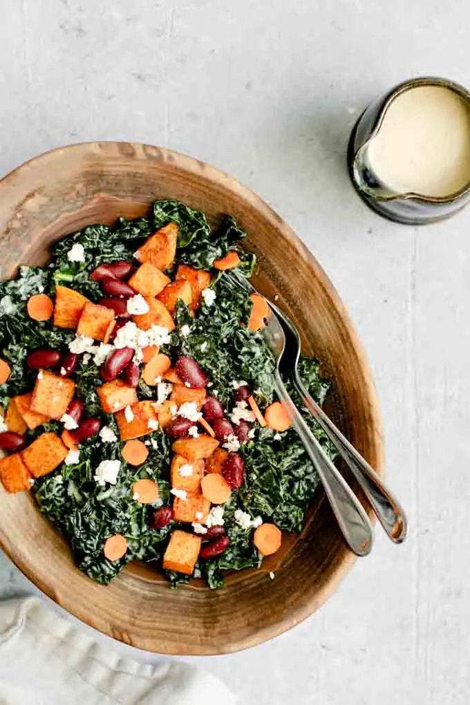 kale salad with roasted garlic tahini dressing, ancho roasted sweet potatoes, and kidney beans