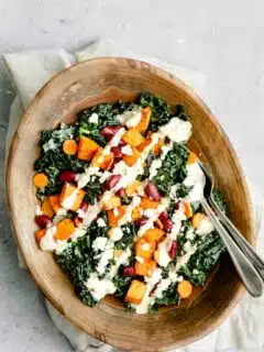 kale salad with roasted garlic tahini dressing, ancho roasted sweet potatoes, and kidney beans