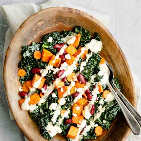 kale salad with roasted garlic tahini dressing, ancho roasted sweet potatoes, and kidney beans