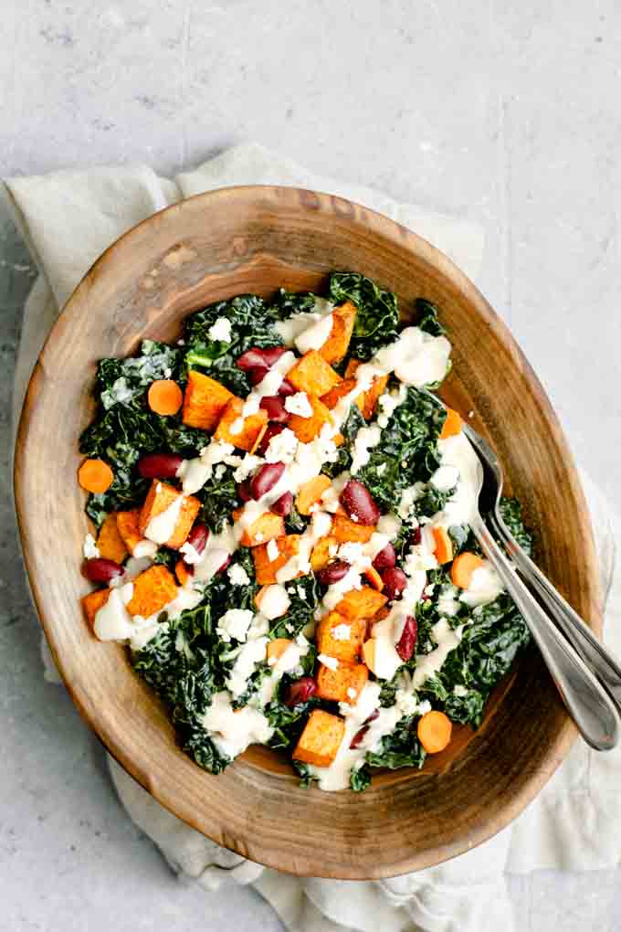 kale salad with roasted garlic tahini dressing, ancho roasted sweet potatoes, and kidney beans