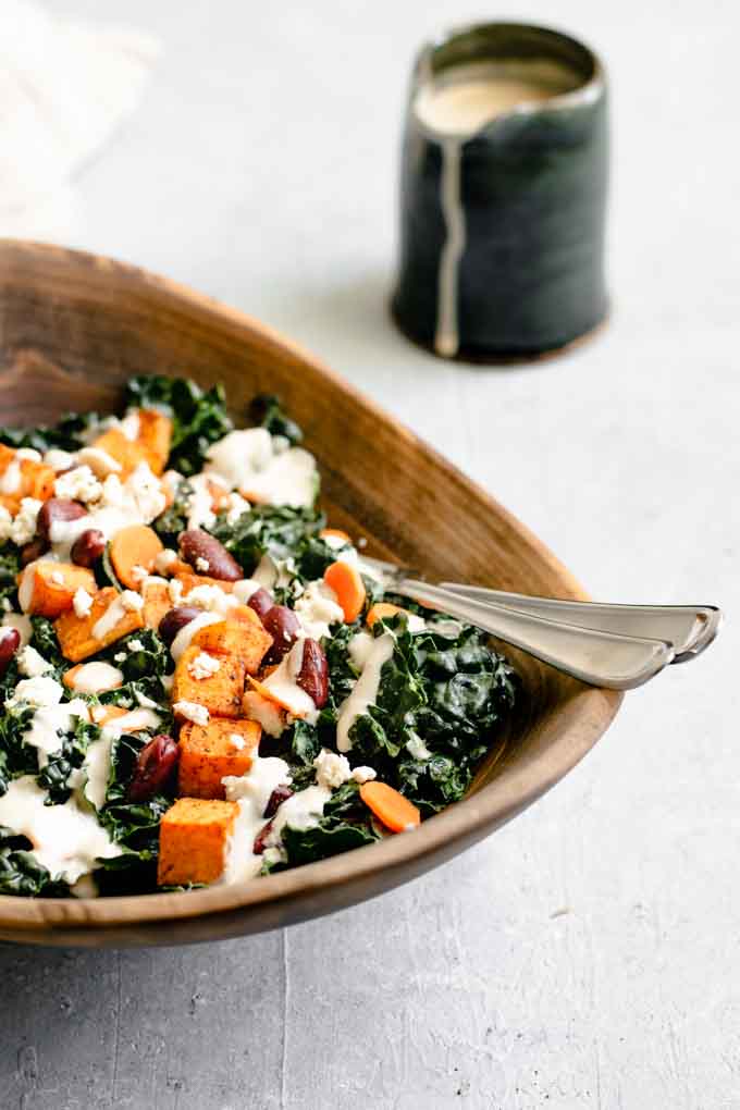 kale salad with roasted garlic tahini dressing, ancho roasted sweet potatoes, and kidney beans