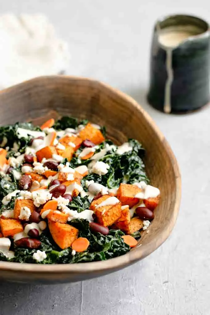 kale salad with roasted garlic tahini dressing, ancho roasted sweet potatoes, and kidney beans