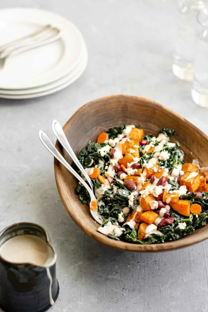 kale salad with roasted garlic tahini dressing, ancho roasted sweet potatoes, and kidney beans