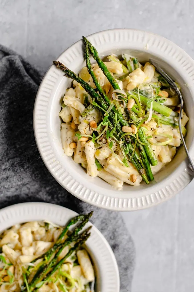 creamy asparagus and leek pasta garnished with panfried asparagus spears and microgreens