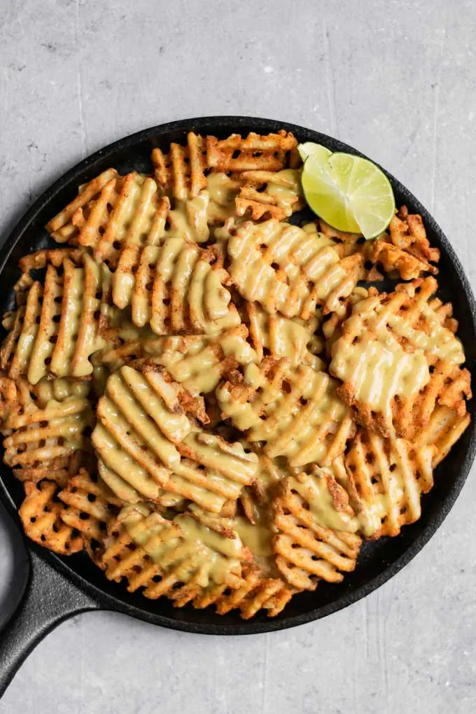 waffle fry nachos smothered in homemade vegan queso