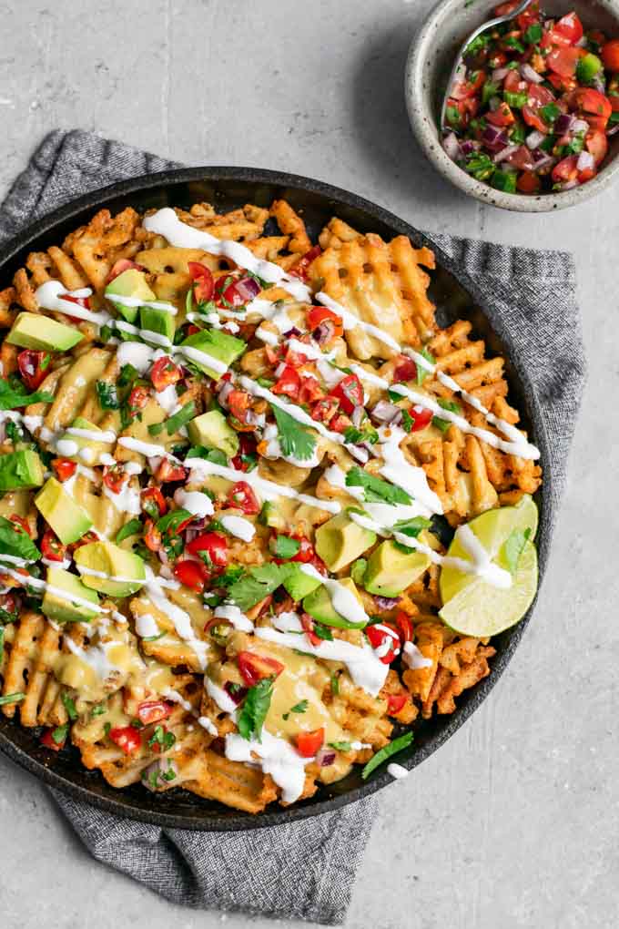 waffle fry nachos with homemade vegan queso and served with pico de gallo