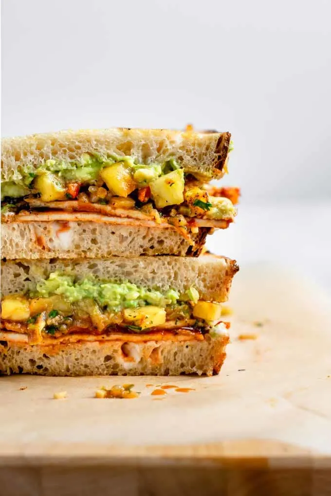 close up of the barbecue tofu sandwich filling with pineapple relish and mashed avocado