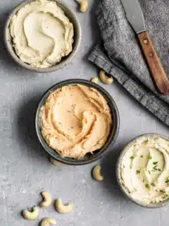 cultured cashew cream cheese, in three bowls, top one is plain, middle is chipotle cream cheese, and bottom in chive cream cheese