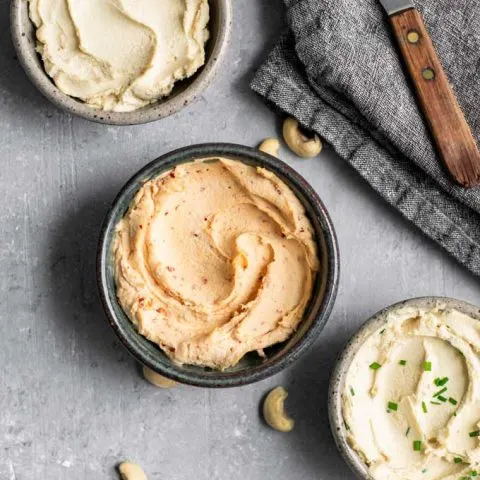 cultured cashew cream cheese, in three bowls, top one is plain, middle is chipotle cream cheese, and bottom in chive cream cheese