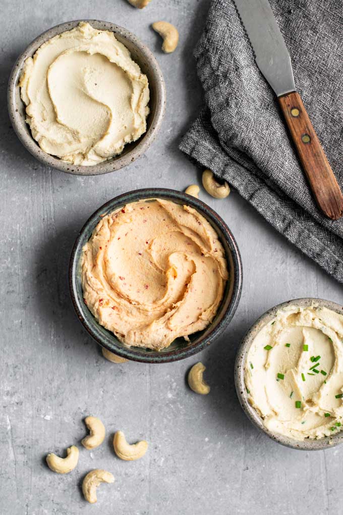 cultured cashew cream cheese, in three bowls, top one is plain, middle is chipotle cream cheese, and bottom in chive cream cheese