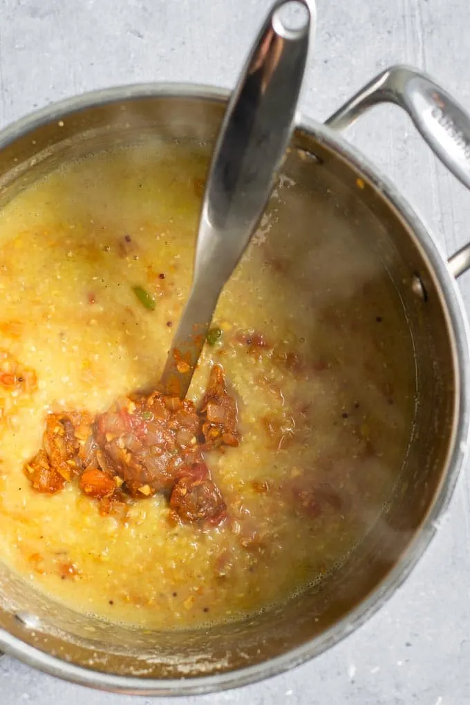 adding the tadka to the cooked masoor dal